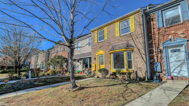 a view of a brick house with many windows