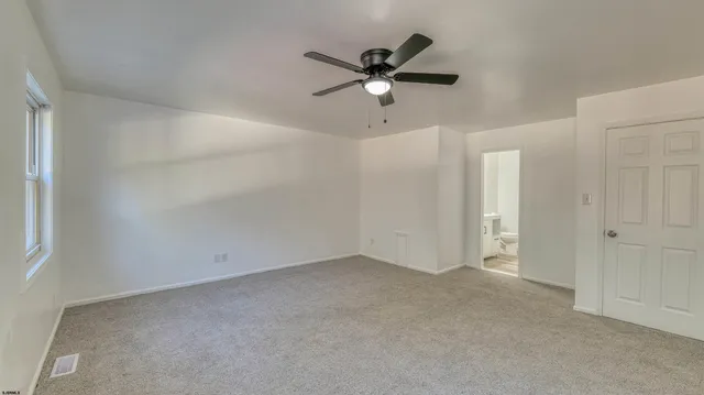 a view of room with a ceiling fan and window