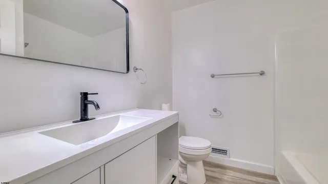 a bathroom with a sink and mirror