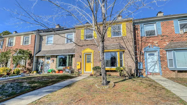 a view of a building with a bench in front of house