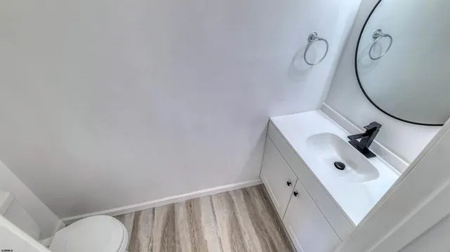 a bathroom with a sink mirror and toilet