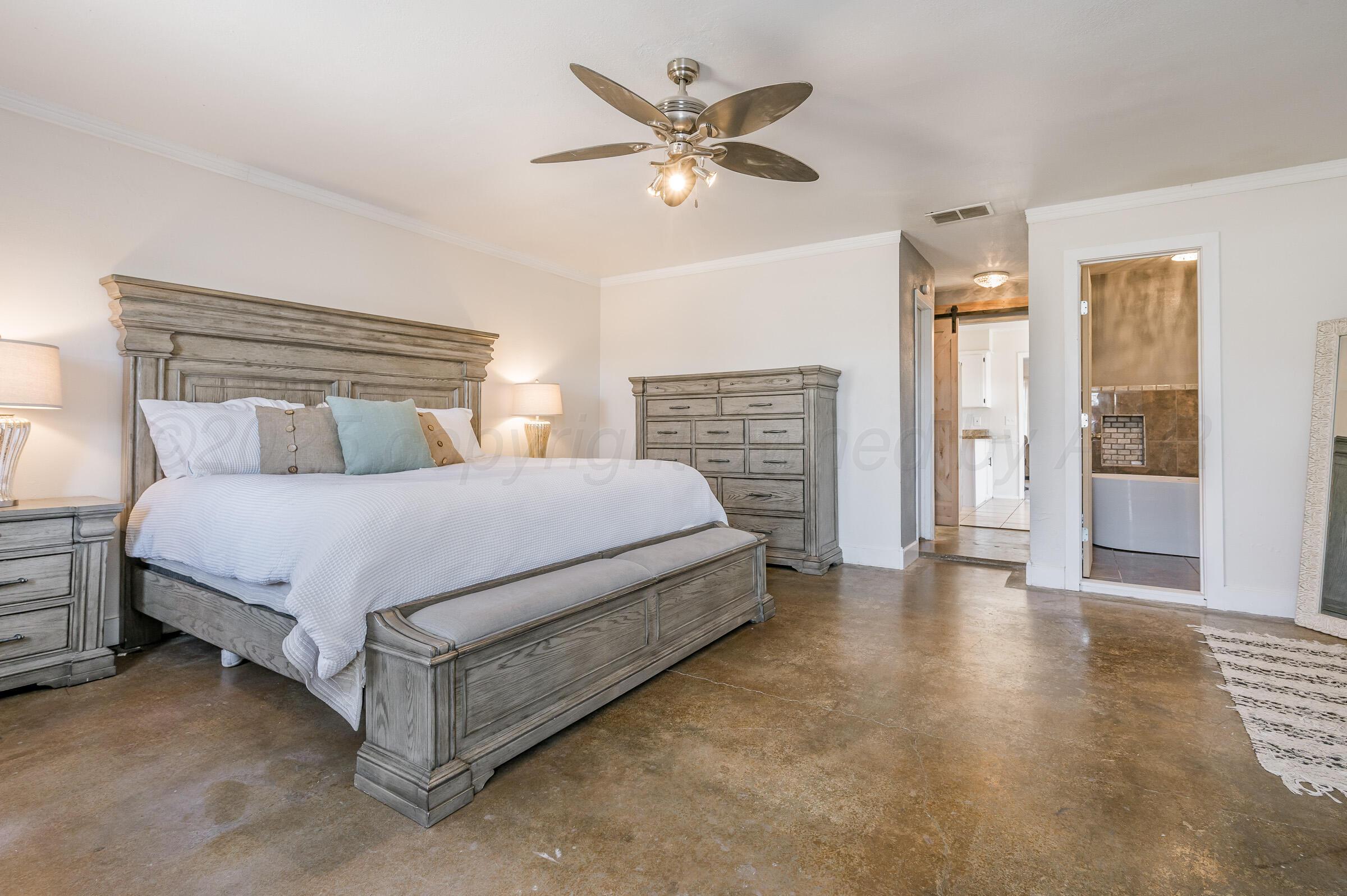 5336 Wheeler Lane Amarillo, TX 79110 - Photo 11 of 24 a spacious bedroom with a bed and a ceiling fan