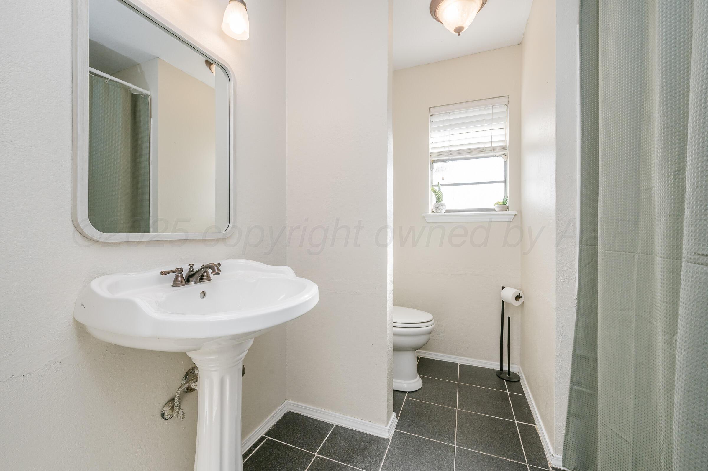 5336 Wheeler Lane Amarillo, TX 79110 - Photo 15 of 24 a bathroom with a sink toilet and a mirror