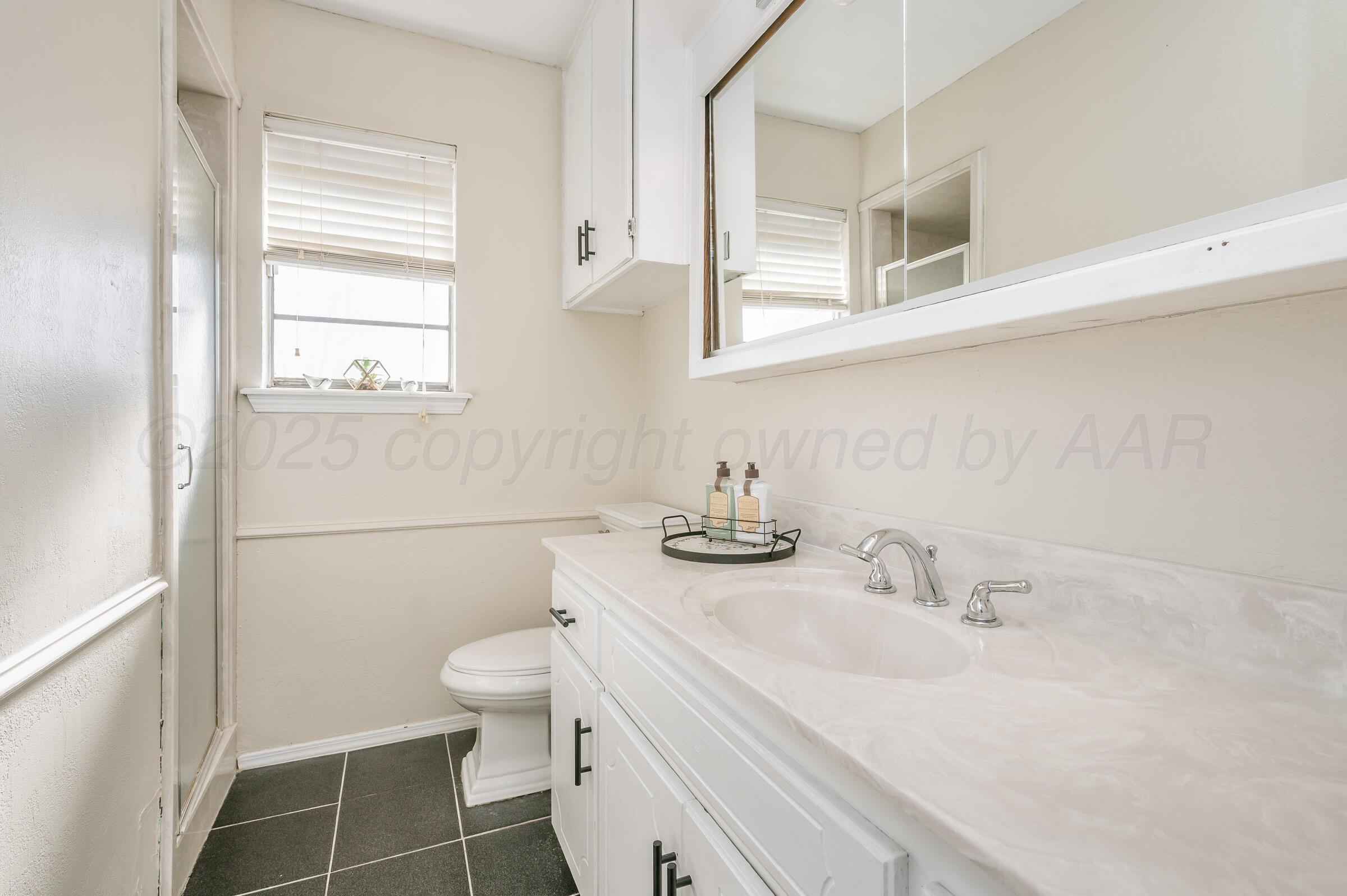 5336 Wheeler Lane Amarillo, TX 79110 - Photo 18 of 24 a bathroom with a sink toilet and vanity