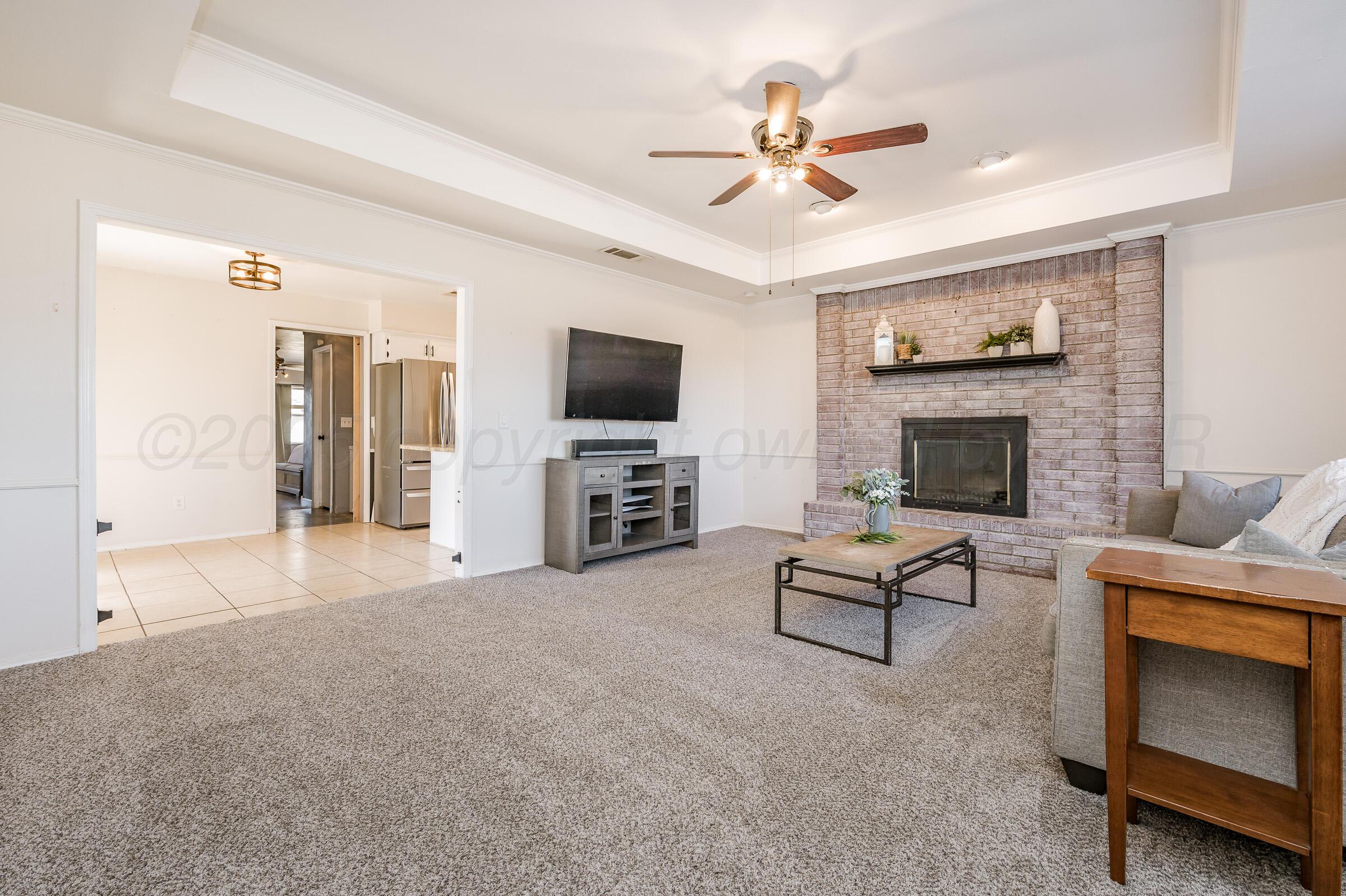 5336 Wheeler Lane Amarillo, TX 79110 - Photo 4 of 24 a living room with furniture and a fireplace