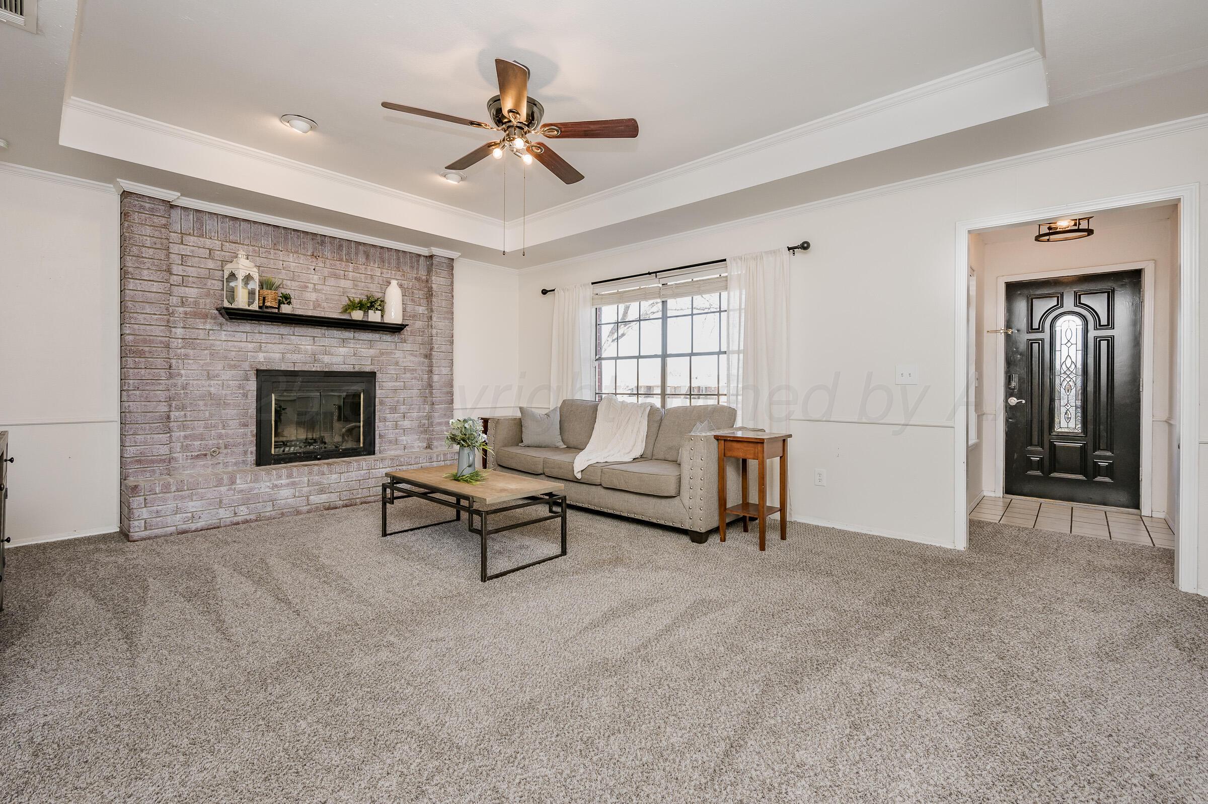 5336 Wheeler Lane Amarillo, TX 79110 - Photo 5 of 24 a living room with furniture and a fireplace