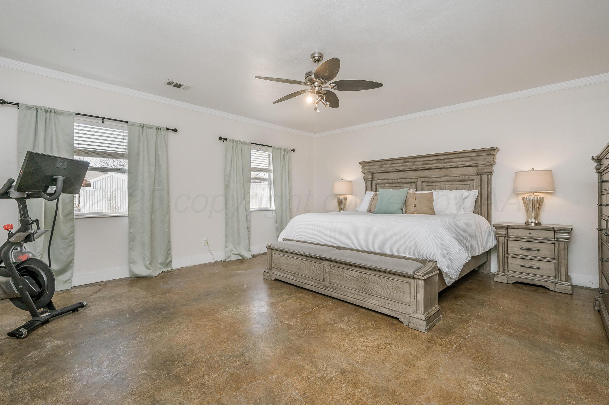 5336 Wheeler Lane Amarillo, TX 79110 - Photo 10 of 24 a spacious bedroom with a bed and a ceiling fan