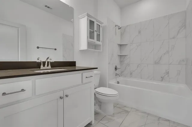 a bathroom with a sink a toilet and a bathtub