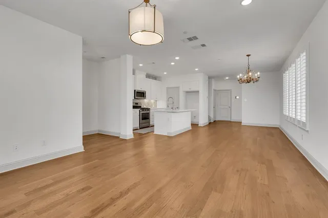 a view of a kitchen with a sink and a refrigerator
