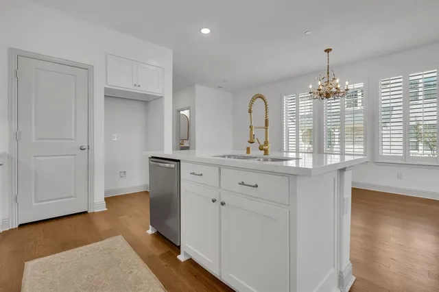 a bathroom with a double vanity sink and mirror with window