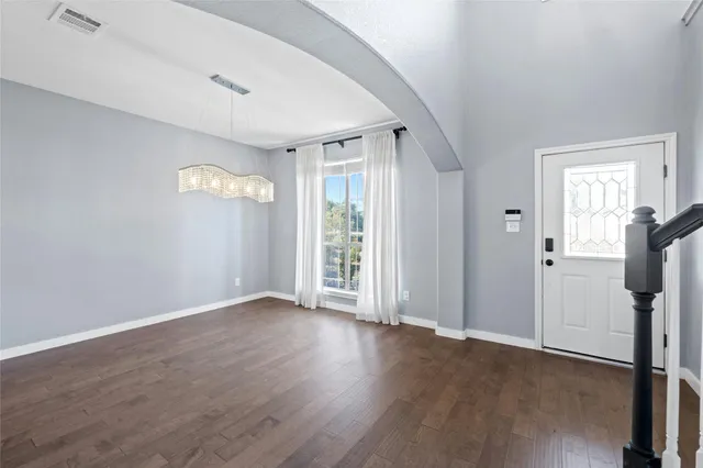 a dining room with furniture potted plants and wooden floor