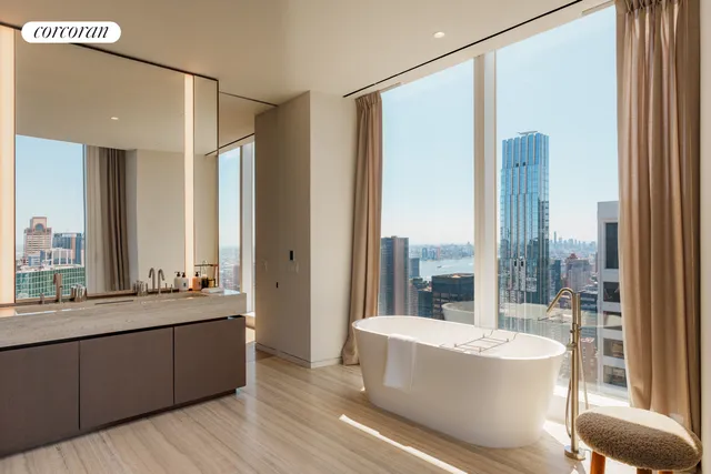 a bedroom with a large window and a bed