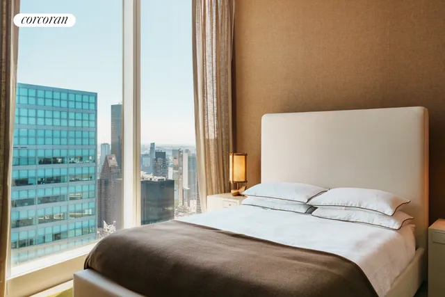 a living room with a large window and a wooden floor