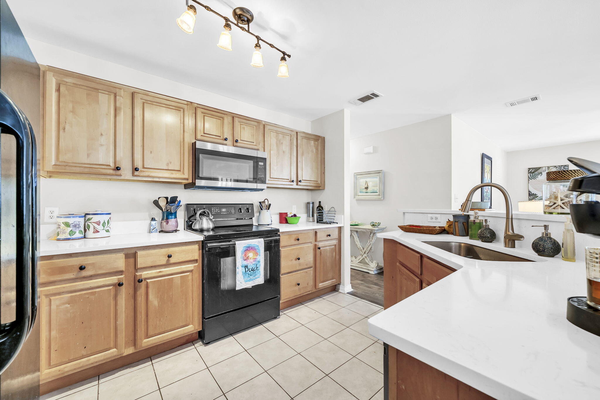 386 Hunters Road Santa Rosa Beach, FL 32459 - Photo 17 of 35 a kitchen with white cabinets and appliances