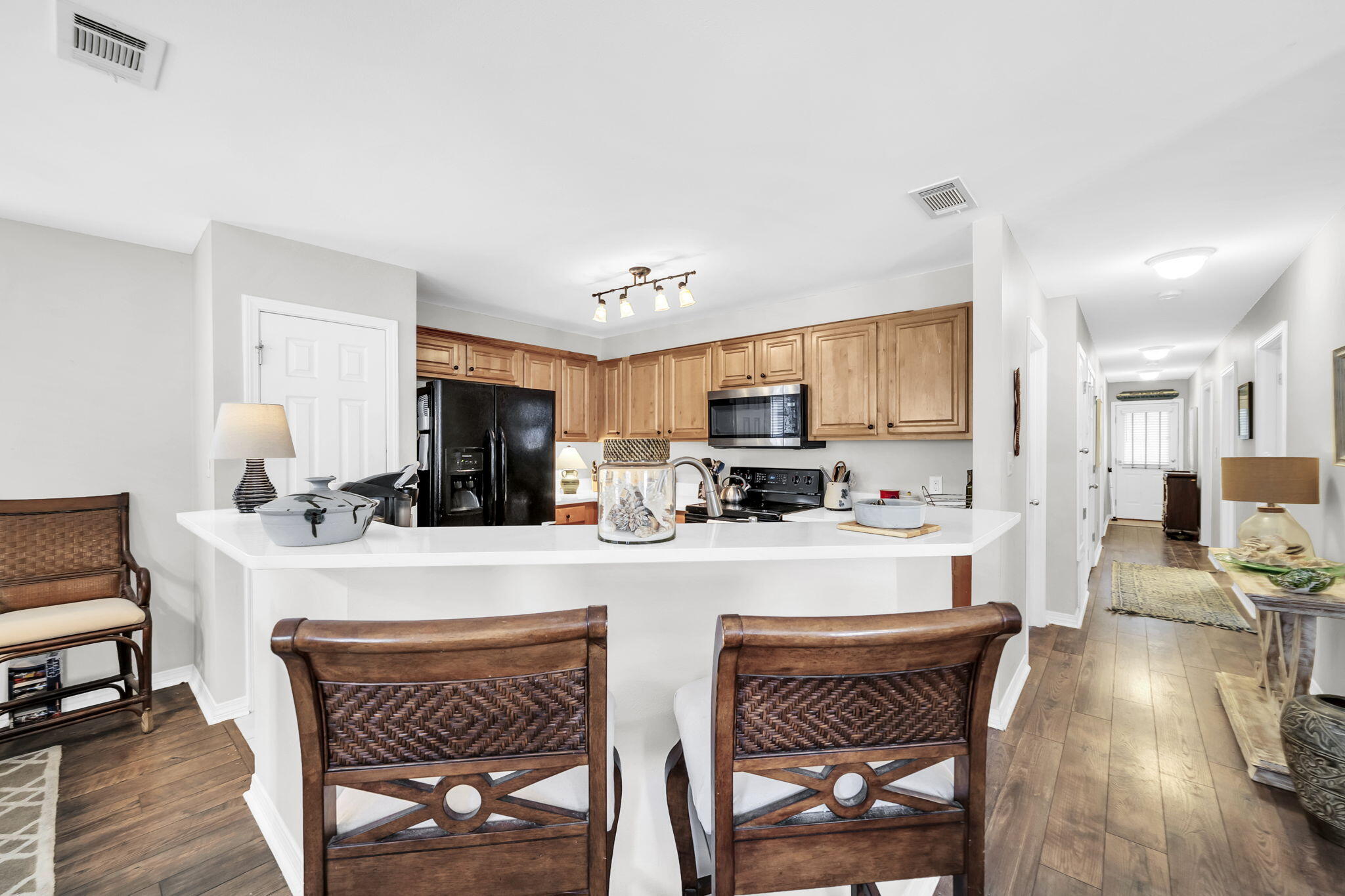 386 Hunters Road Santa Rosa Beach, FL 32459 - Photo 18 of 35 a kitchen with stainless steel appliances a table and chairs in it