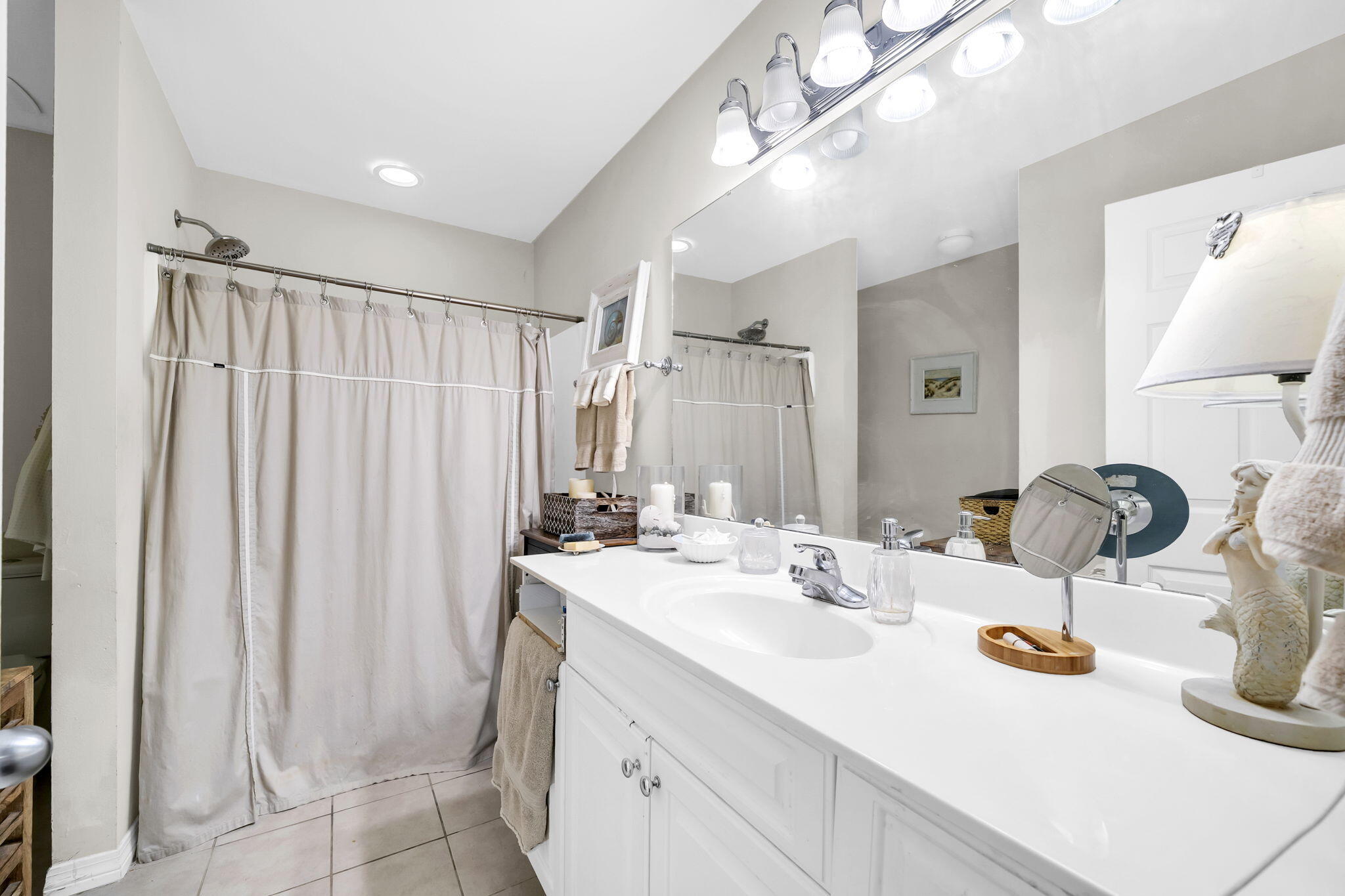 386 Hunters Road Santa Rosa Beach, FL 32459 - Photo 23 of 35 a bathroom with a double vanity sink and a mirror