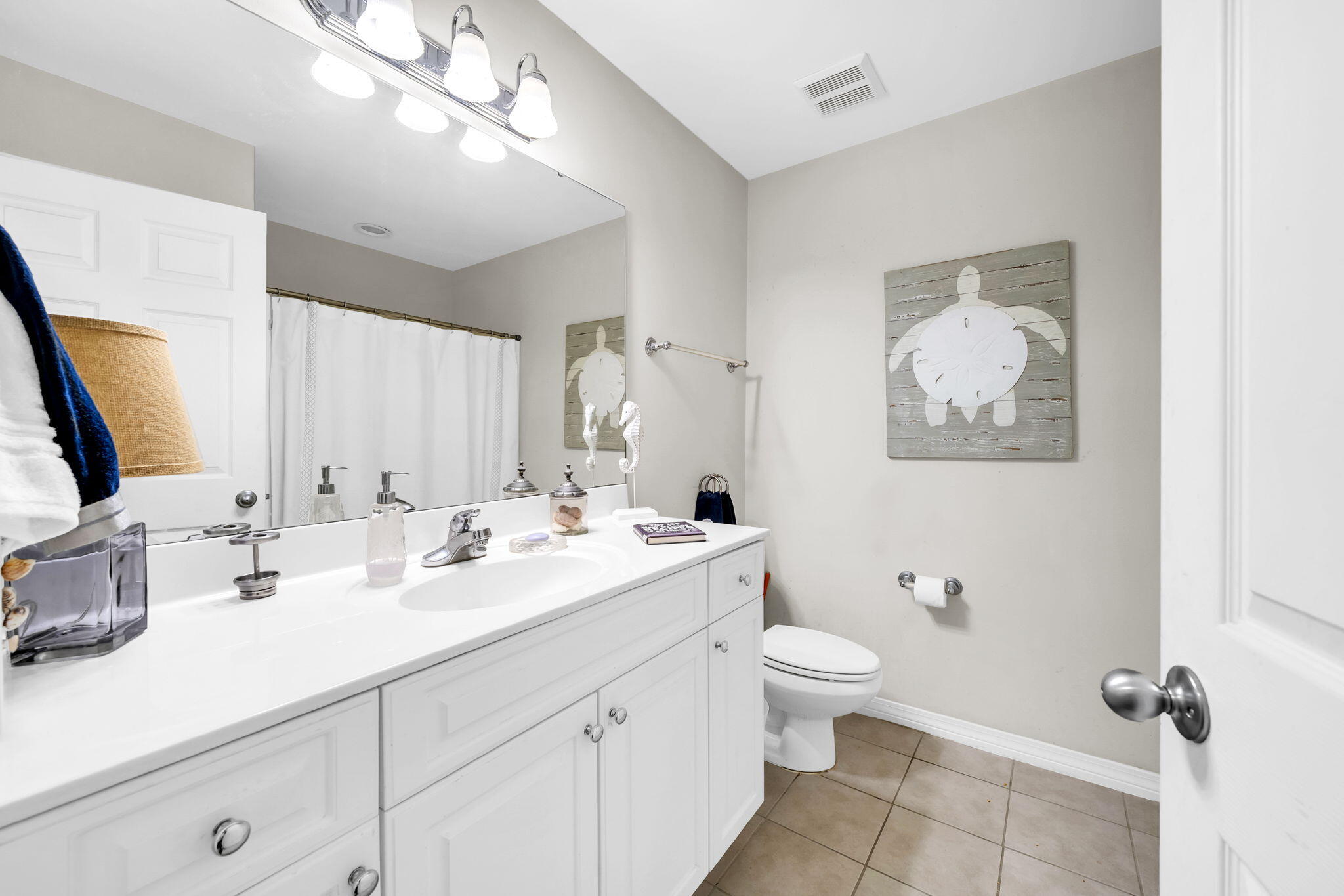386 Hunters Road Santa Rosa Beach, FL 32459 - Photo 27 of 35 a bathroom with a double vanity sink toilet and mirror