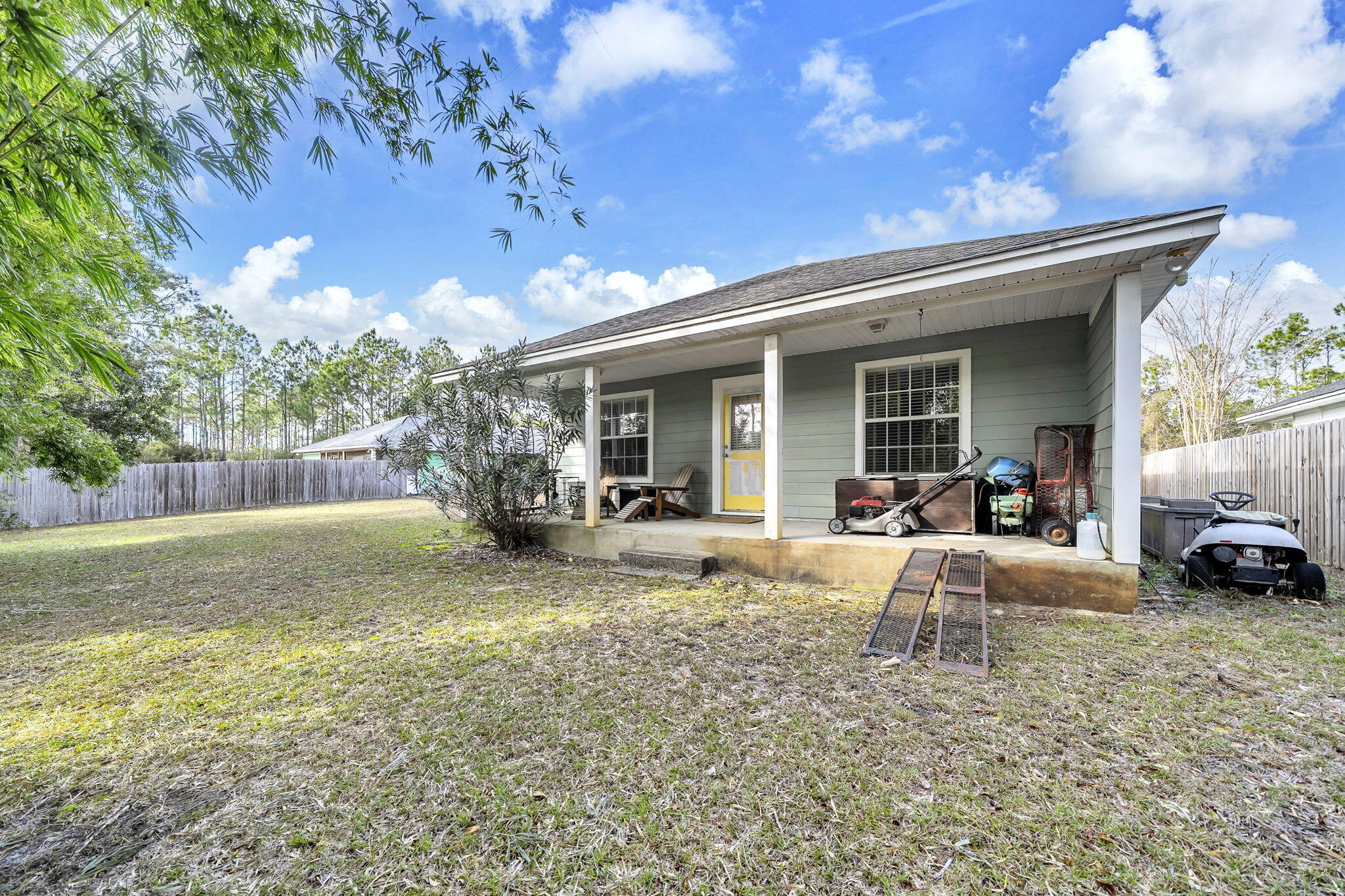 386 Hunters Road Santa Rosa Beach, FL 32459 - Photo 34 of 35 a view of a house with backyard porch and sitting area