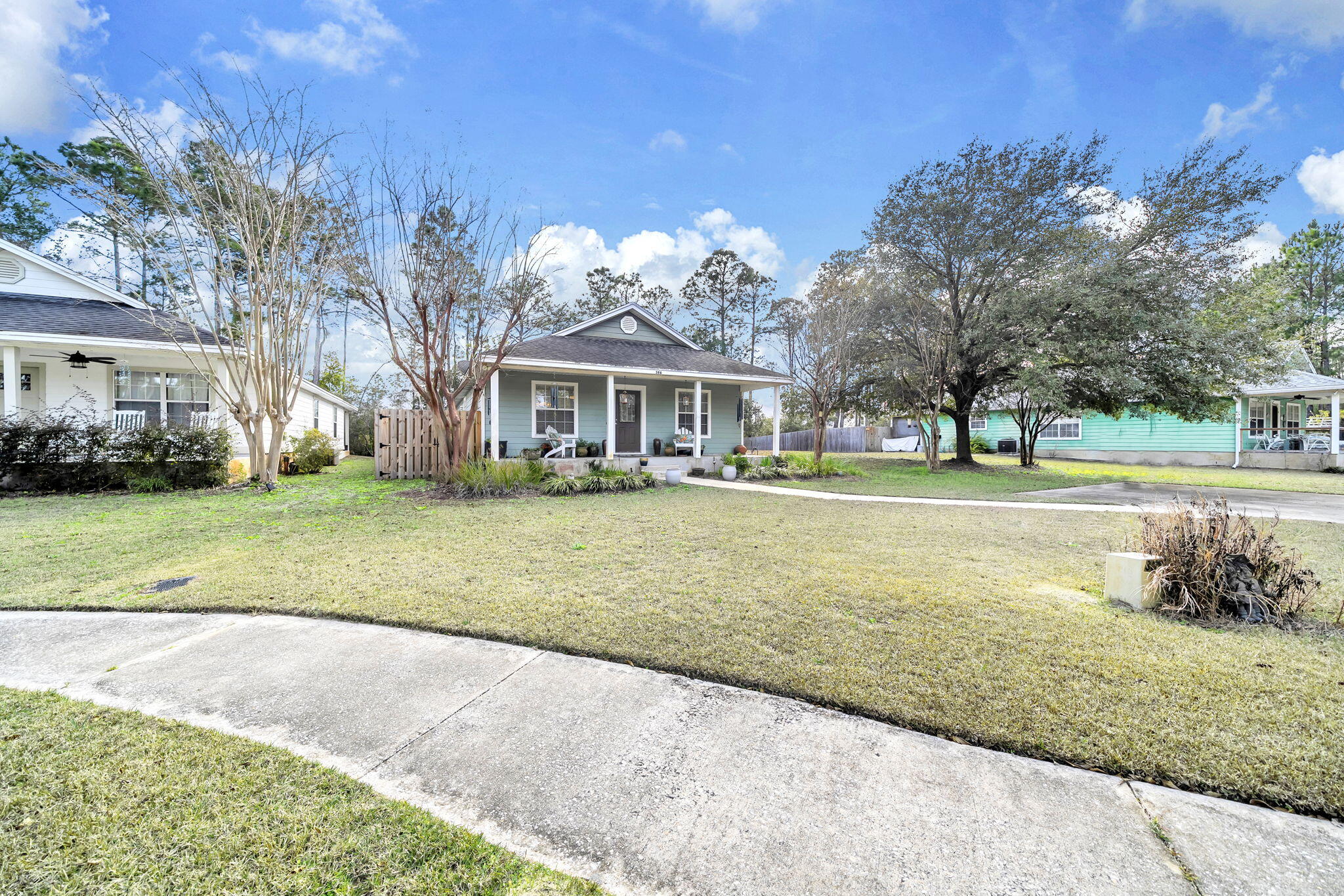 386 Hunters Road Santa Rosa Beach, FL 32459 - Photo 6 of 35 a front view of a building with a yard