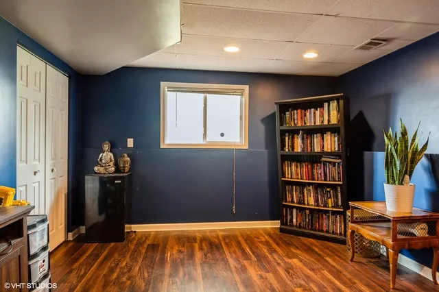 a room with a book shelf and a window