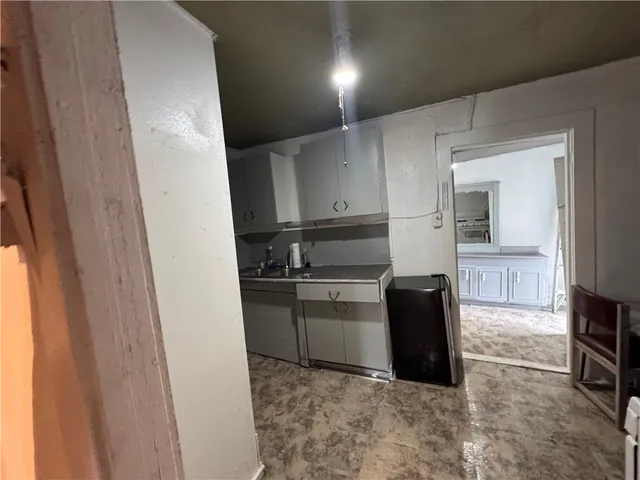a kitchen with a refrigerator stove and wooden cabinets