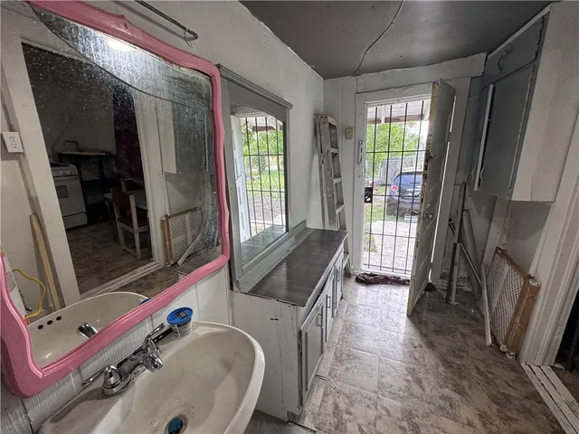a bathroom with a tub a sink and a mirror