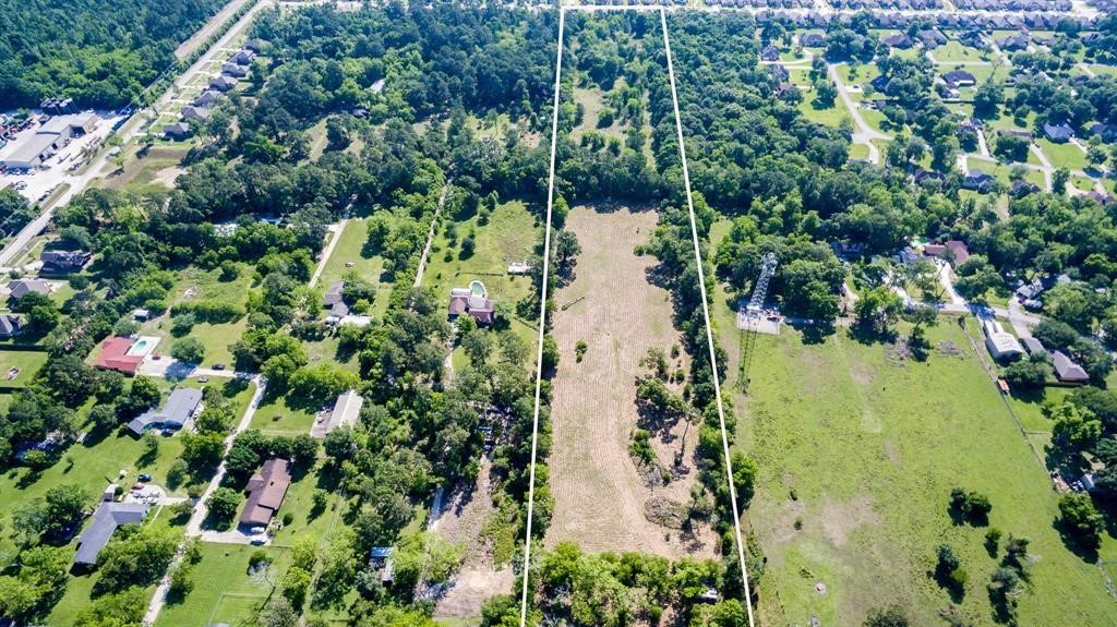 6716 Sjolander Road Baytown, TX 77521 - Photo 3 of 26 This aerial photo showcases a large, Ready for developed parcel of land bordered by residential neighborhoods, offering a blank canvas for potential development or a private estate within an established community.
