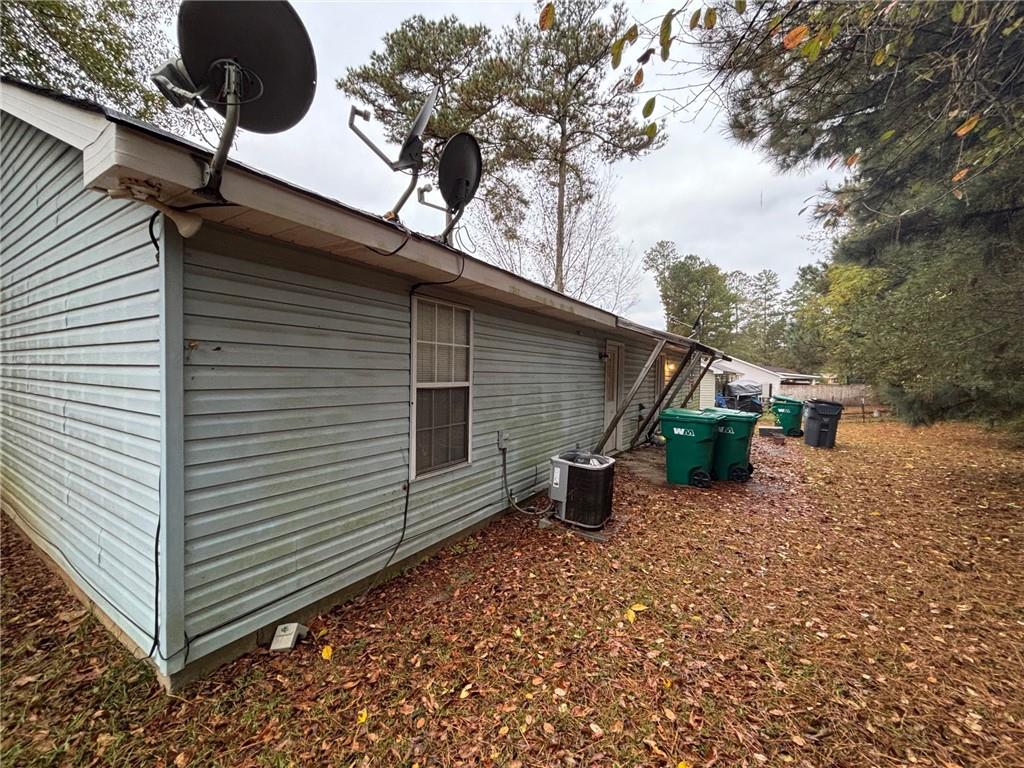2361 River Ridge Road Northeast Milledgeville, GA 31061 - Photo 11 of 12 a backyard of a house with table and chairs under an umbrella