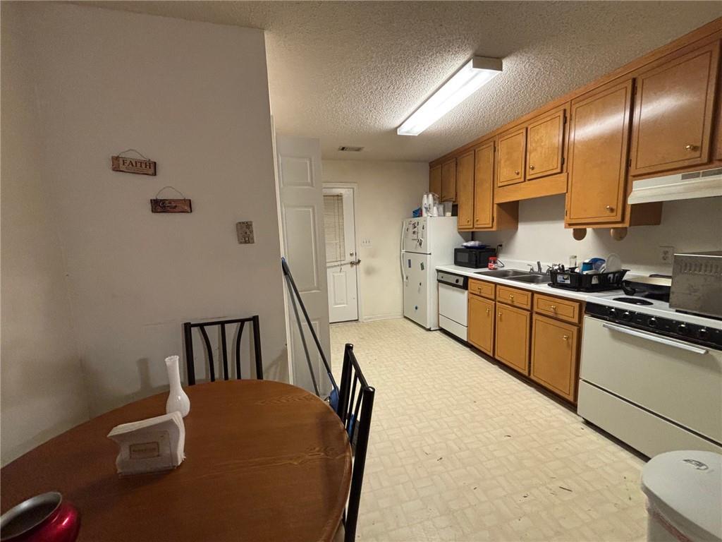 2361 River Ridge Road Northeast Milledgeville, GA 31061 - Photo 2 of 12 a kitchen with sink cabinets and stainless steel appliances