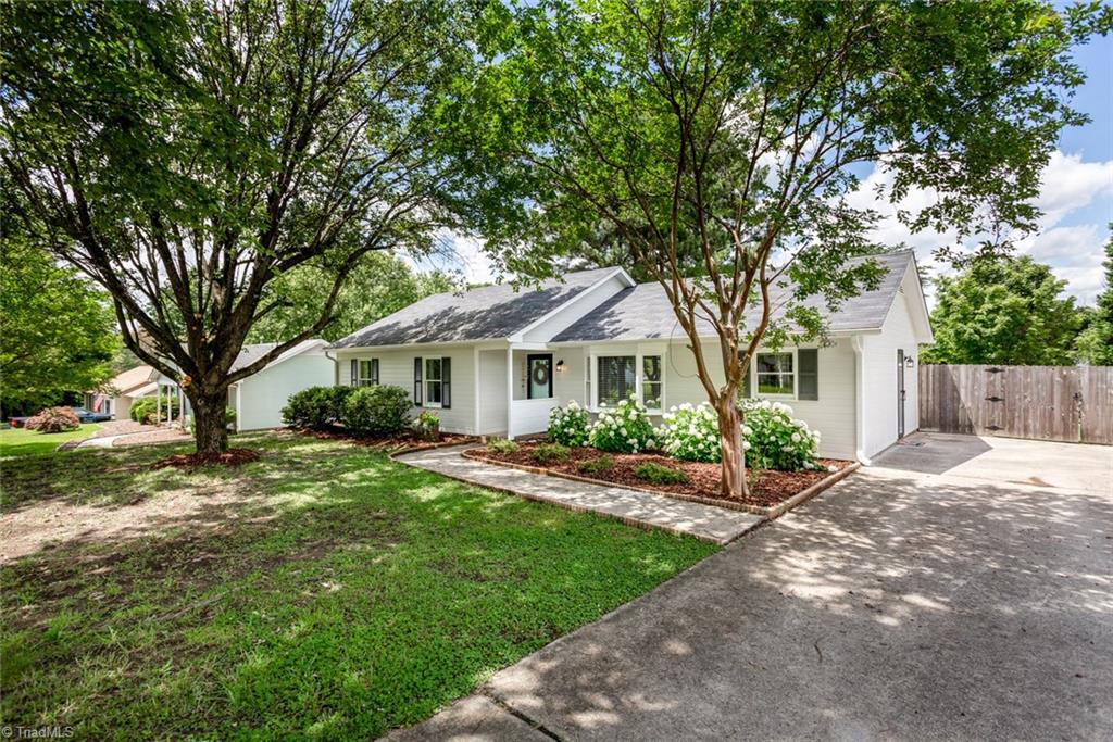 Charming 3 bedroom ranch with a double parking pad for two cars.