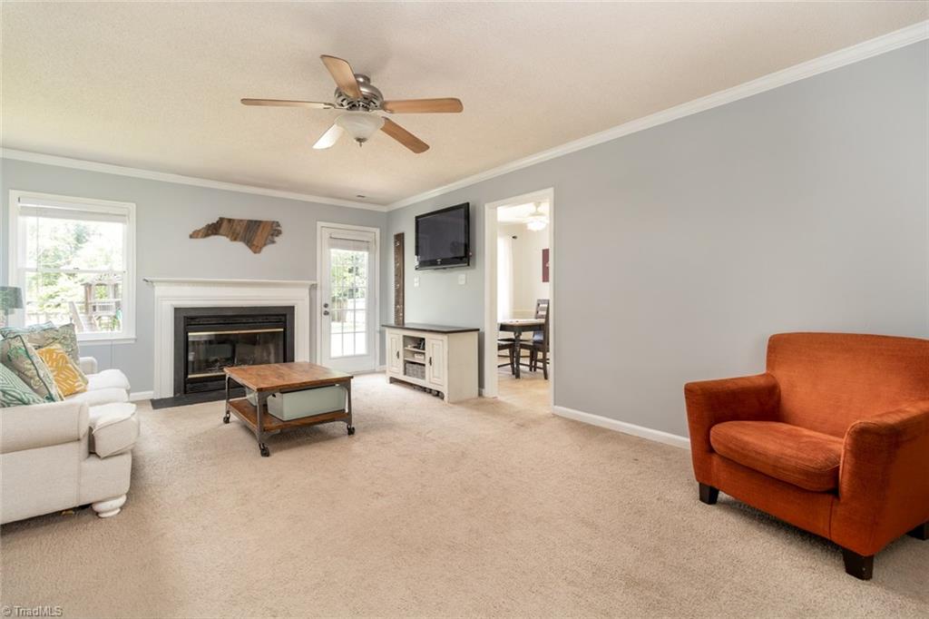 2453 Willard Road High Point, NC 27265 - Photo 7 of 29 Living room has a cozy fireplace and opens into the breakfast area.