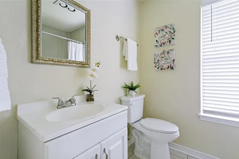 a bathroom with a sink mirror and toilet