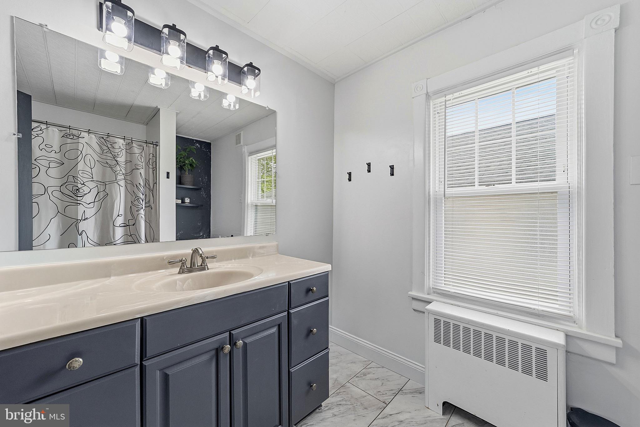 15 South Clinton Avenue Maple Shade, NJ 08052 - Photo 16 of 29 a bathroom with a sink vanity and a mirror