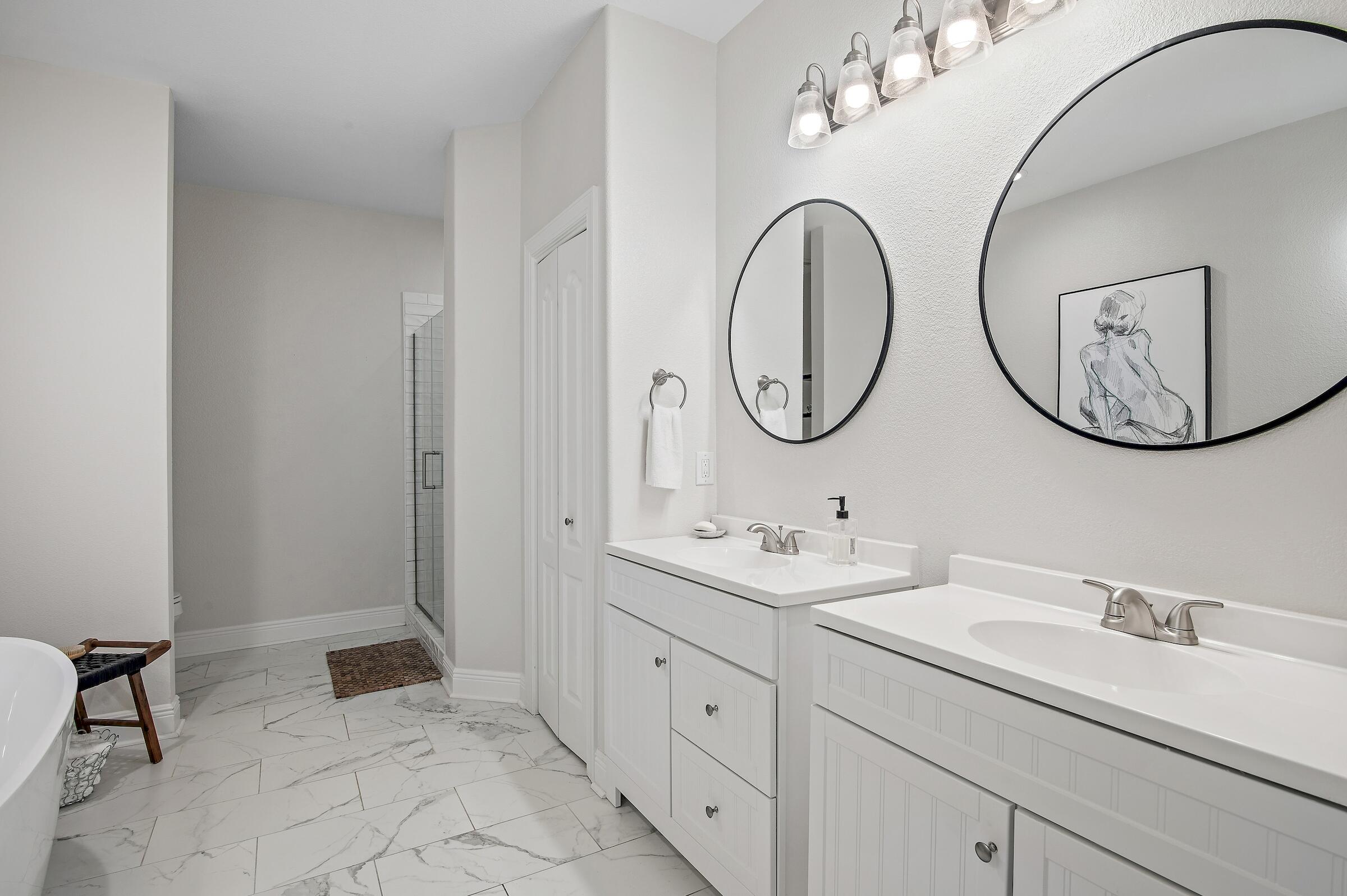 4202 Jade Loop Destin, FL 32541 - Photo 16 of 29 a bathroom with a double vanity sink and a mirror