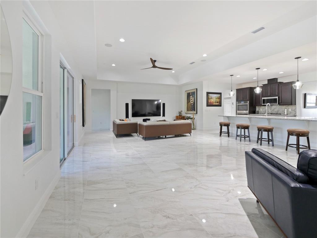 5264 Obsidian Gate Road Mount Dora, FL 32757 - Photo 20 of 49 a living room with furniture and a flat screen tv