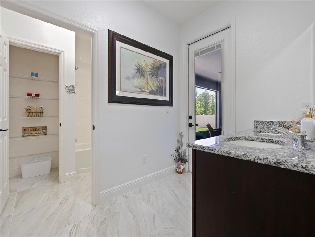 5264 Obsidian Gate Road Mount Dora, FL 32757 - Photo 24 of 49 a bathroom with a granite countertop sink