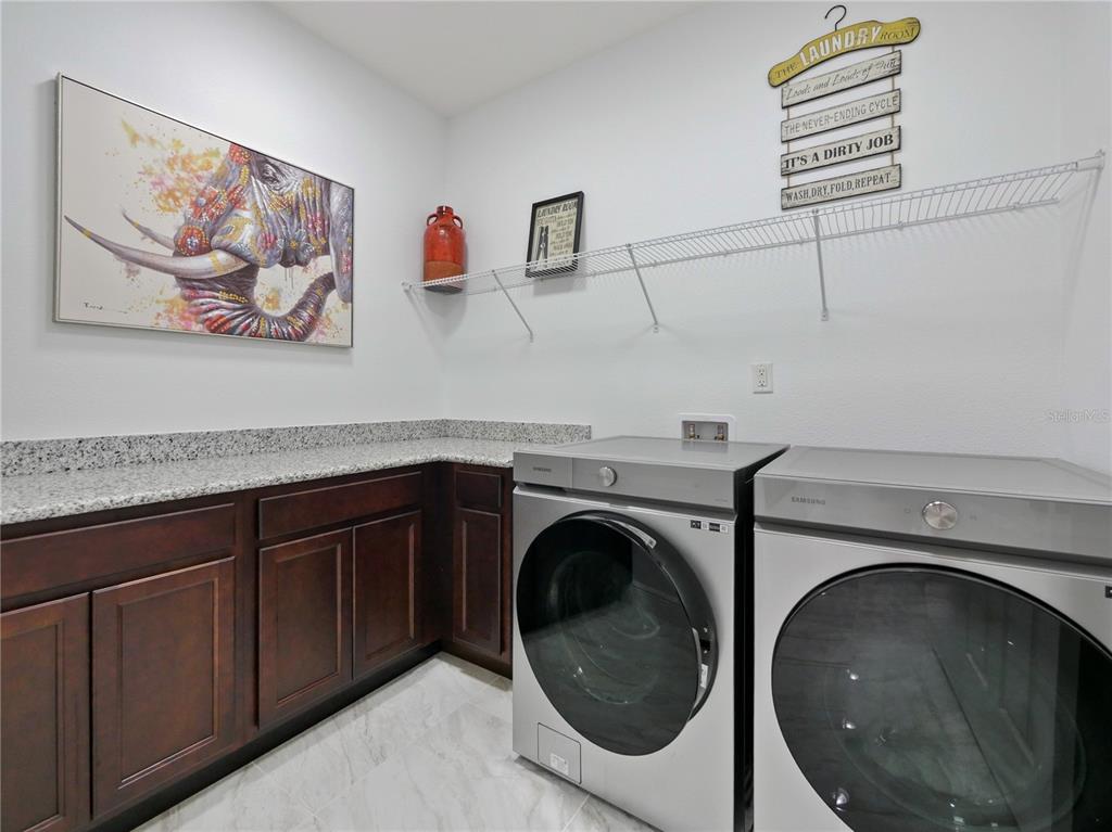 5264 Obsidian Gate Road Mount Dora, FL 32757 - Photo 34 of 49 a utility room with dryer and washer