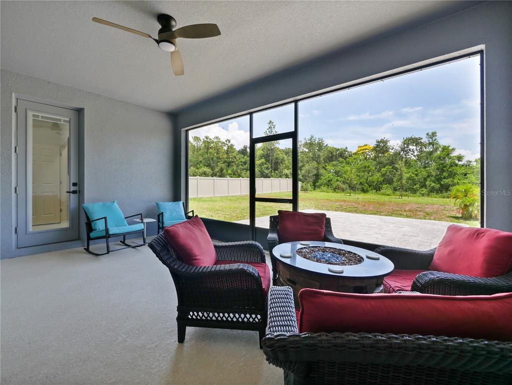 5264 Obsidian Gate Road Mount Dora, FL 32757 - Photo 35 of 49 a living room with furniture and a floor to ceiling window