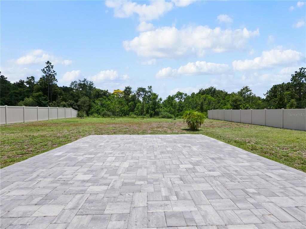 5264 Obsidian Gate Road Mount Dora, FL 32757 - Photo 38 of 49 a view of an outdoor space and a yard