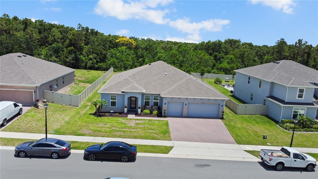 5264 Obsidian Gate Road Mount Dora, FL 32757 - Photo 40 of 49 aerial view of a house with a garden and yard