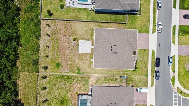 an aerial view of a tennis ground and swimming pool