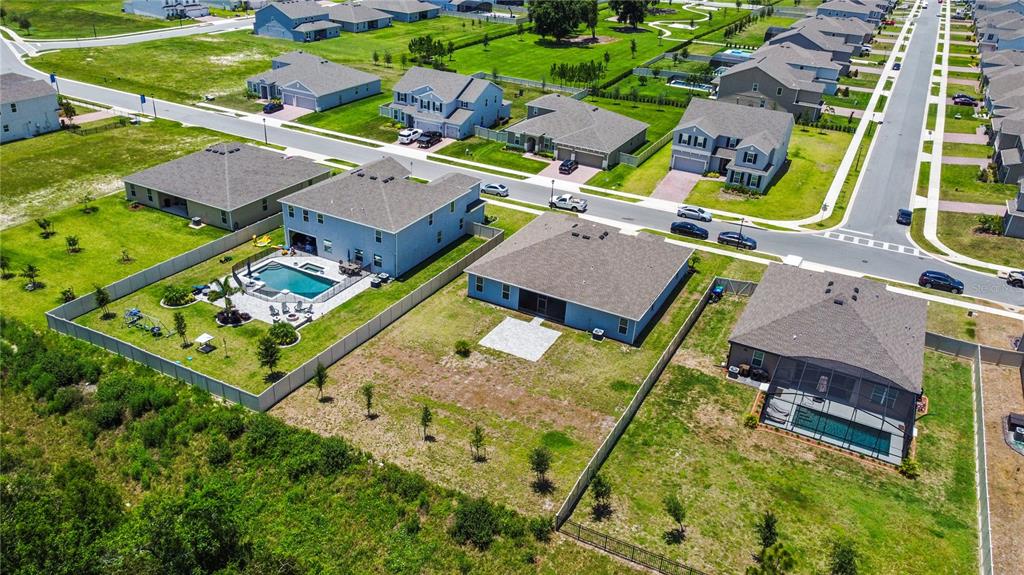 5264 Obsidian Gate Road Mount Dora, FL 32757 - Photo 43 of 49 an aerial view of a house with a garden