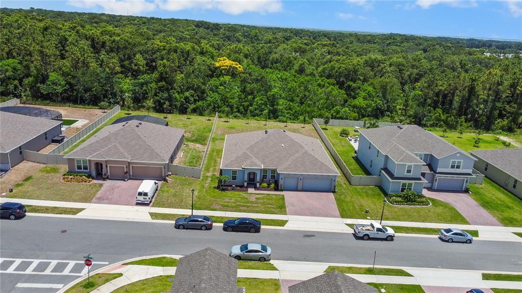 5264 Obsidian Gate Road Mount Dora, FL 32757 - Photo 44 of 49 an aerial view of a tennis ground and large trees