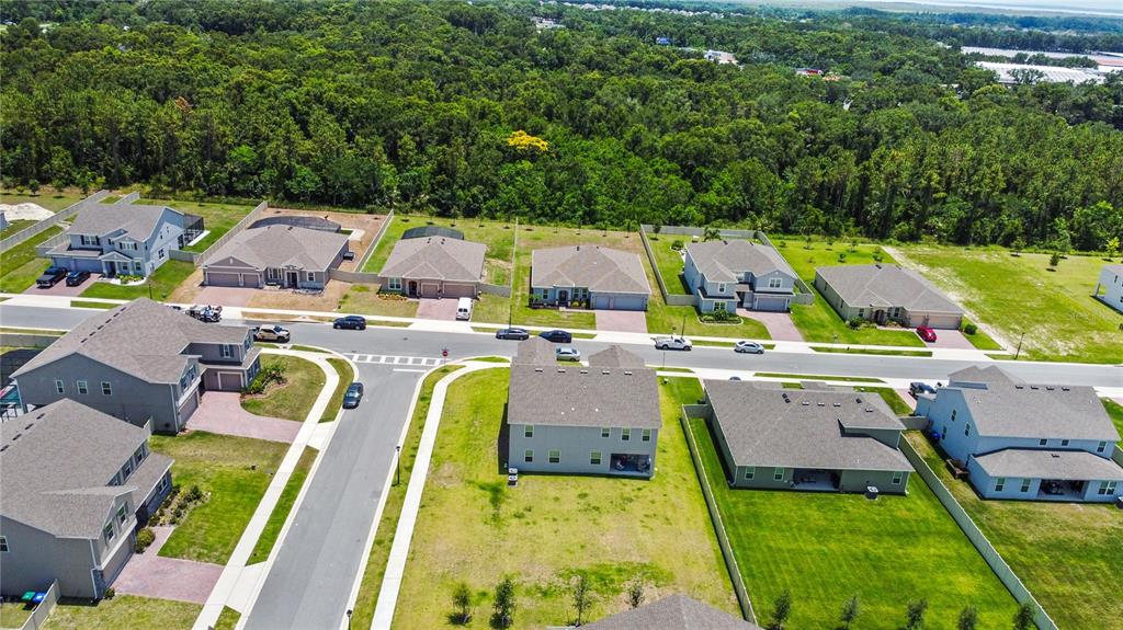 5264 Obsidian Gate Road Mount Dora, FL 32757 - Photo 45 of 49 an aerial view of residential houses with outdoor space and swimming pool