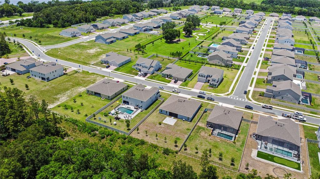 5264 Obsidian Gate Road Mount Dora, FL 32757 - Photo 47 of 49 an aerial view of a house with a garden