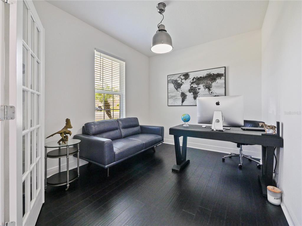 5264 Obsidian Gate Road Mount Dora, FL 32757 - Photo 5 of 49 a living room with furniture a window and wooden floor