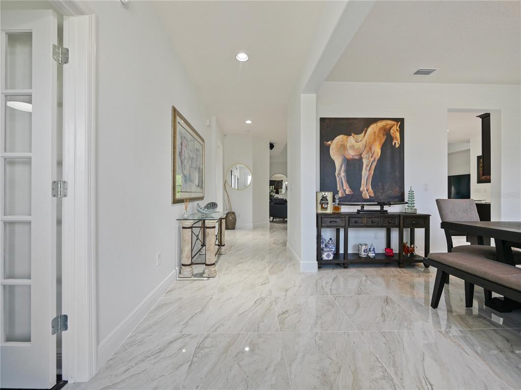5264 Obsidian Gate Road Mount Dora, FL 32757 - Photo 6 of 49 a living room with furniture and a flat screen tv