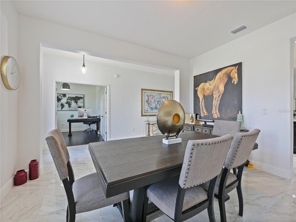 5264 Obsidian Gate Road Mount Dora, FL 32757 - Photo 8 of 49 a view of a dining room that has a table and chairs