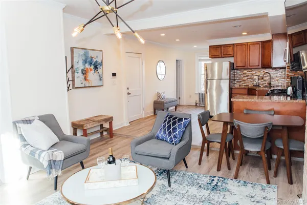 a living room with furniture a refrigerator and a dining table