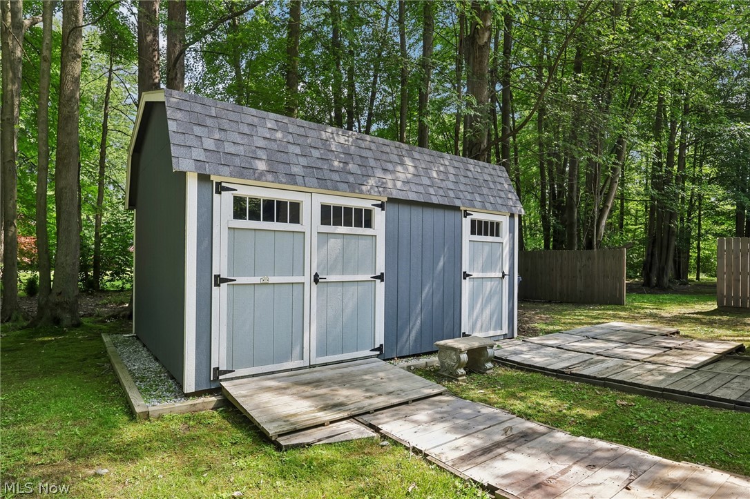 3213 Bates Road Madison, OH 44057 - Photo 37 of 45 Detached storage shed with a gambrel roof and asphalt shingles